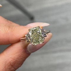 GIA-certified greenish yellow diamond ring with a radiant cut center stone and VVS2 clarity.