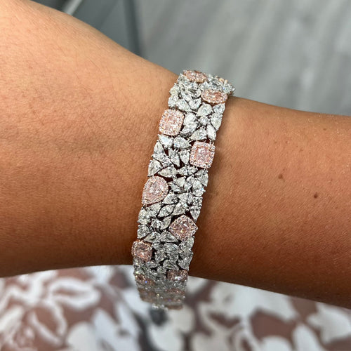 GIA certified light pink cushion and pear shape diamonds with white diamond bracelet.