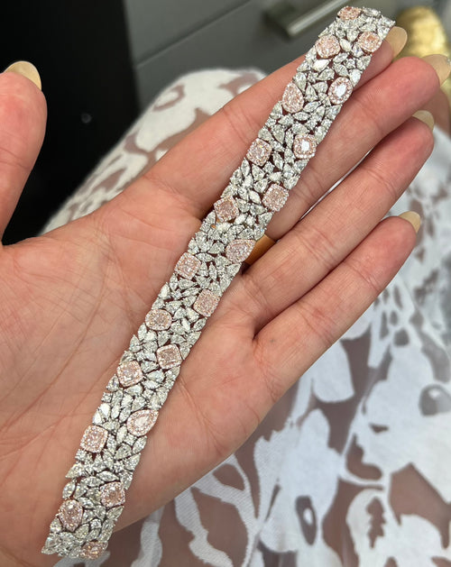 GIA certified light pink cushion and pear shape diamonds with white diamond bracelet.