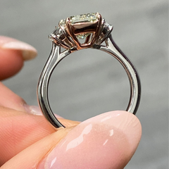 GIA-certified greenish yellow diamond ring with a radiant cut center stone and VVS2 clarity.