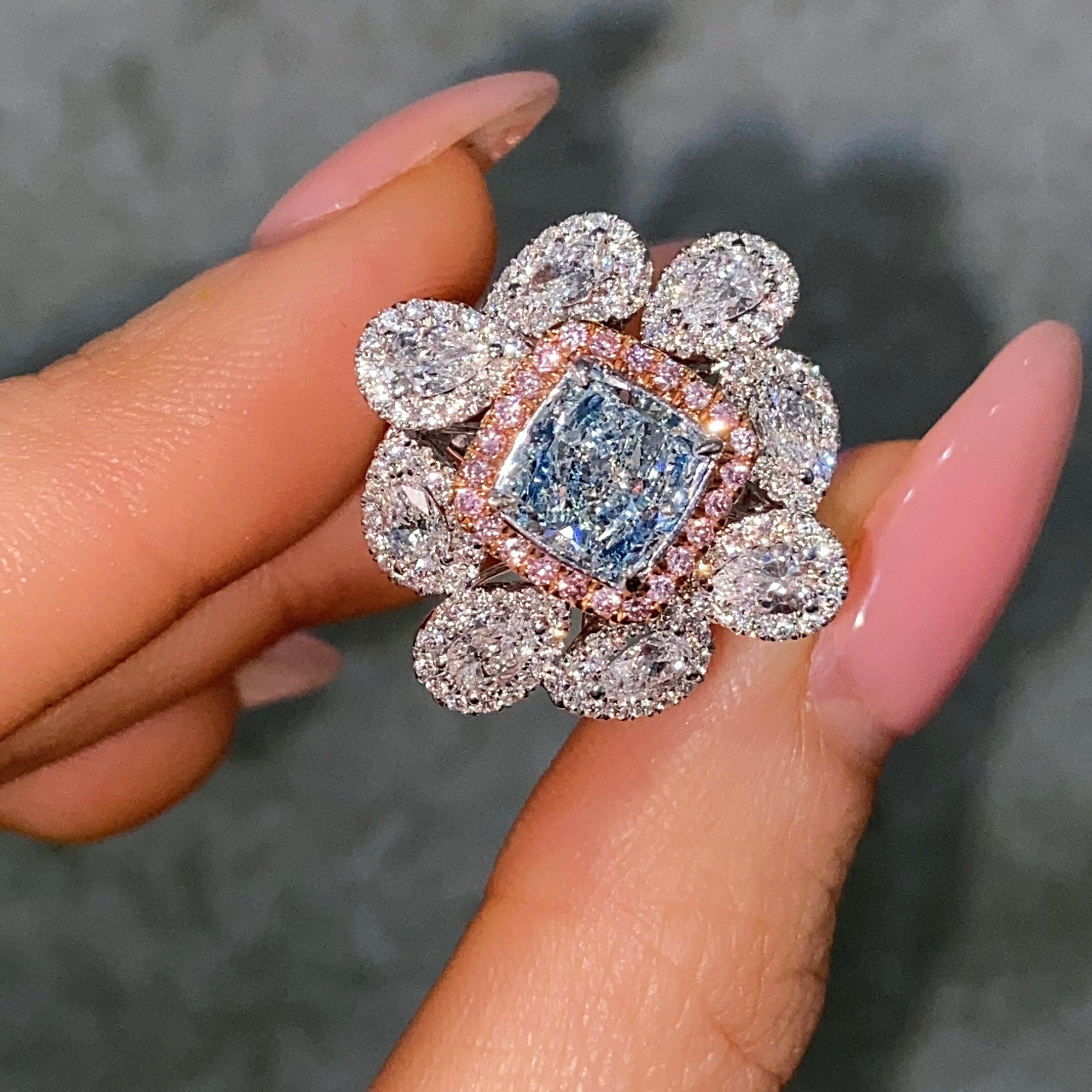 blue diamond ring on female hand
