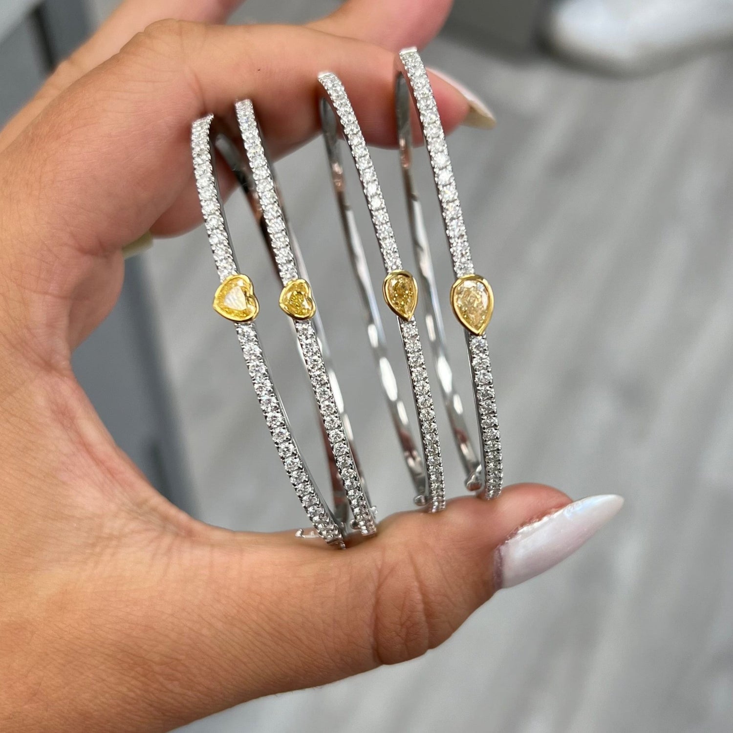 Unique heart shaped yellow diamond bangle with elongated white round diamonds and SI-VS1 clarity.