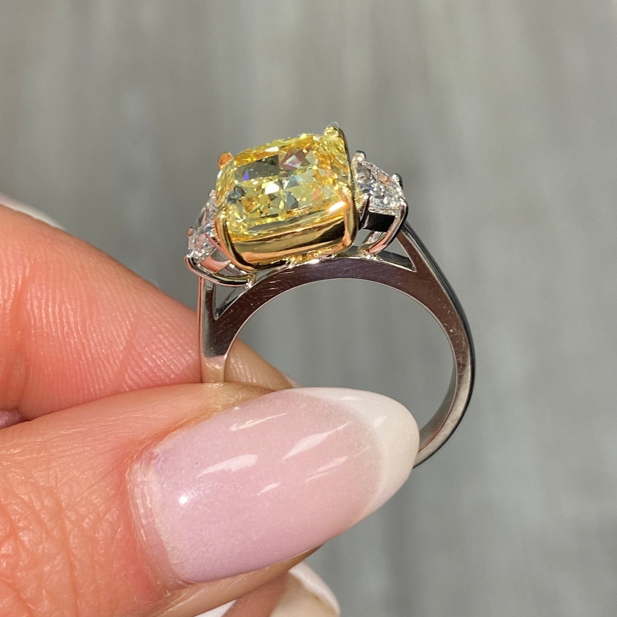 GIA certified Fancy Yellow Cushion Diamond Engagement Ring with VS2 clarity and excellent cutting.