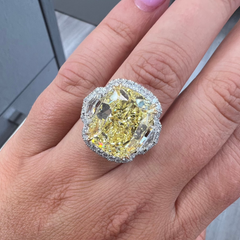 13.30 carat yellow diamond on the center with white surrounding diamonds