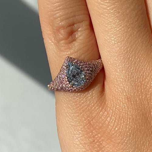 Unique GIA certified light blue pear shape diamond ring set with natural pink diamonds.