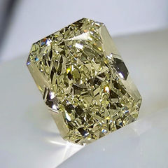 Unique light yellow elongated radiant cut diamond with VS2 clarity and warm, vibrant hue.