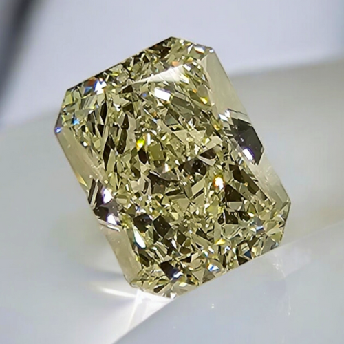 Unique light yellow elongated radiant cut diamond with VS2 clarity and warm, vibrant hue.