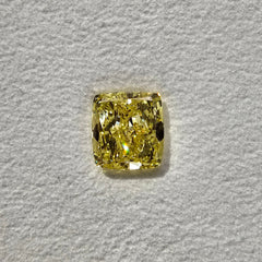 GIA certified fancy light yellow elongated cushion cut diamond with VVS2 clarity.