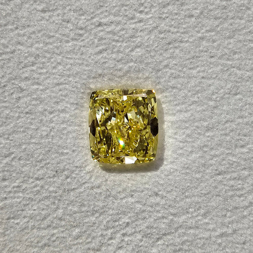GIA certified fancy light yellow elongated cushion cut diamond with VVS2 clarity.