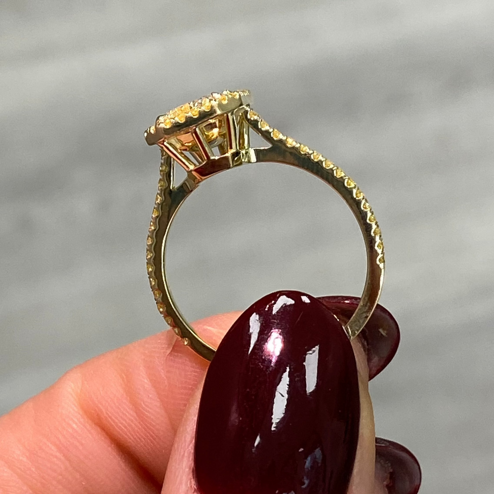 Elongated natural yellow diamond ring featuring a GIA-certified light yellow radiant diamond.