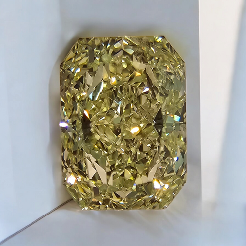 Elegant elongated radiant diamond with a fancy light yellow hue.