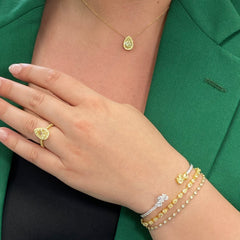 2.5 carat yellow diamond pear shape set in 18 karat yellow gold pendant with yellow diamond round halo