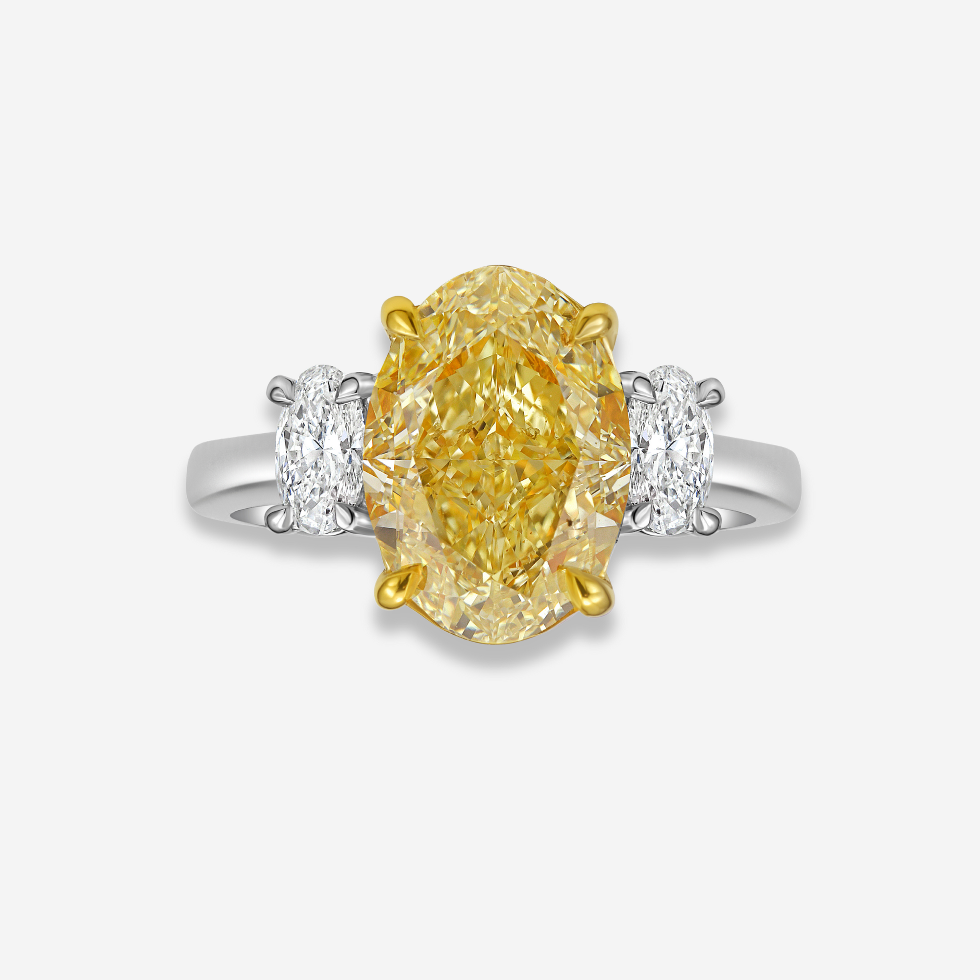 Ring with a oval yellow diamond and two smaller diamonds on a white background
