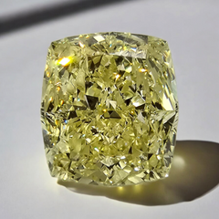 Elegant elongated cushion cut diamond with a soft Fancy Light Yellow hue and exceptional VVS2 clarity.