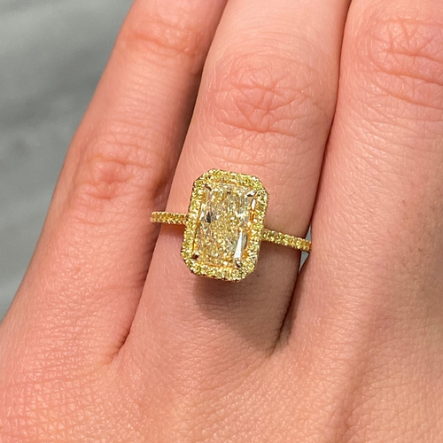 Elongated natural yellow diamond ring featuring a GIA-certified light yellow radiant diamond.