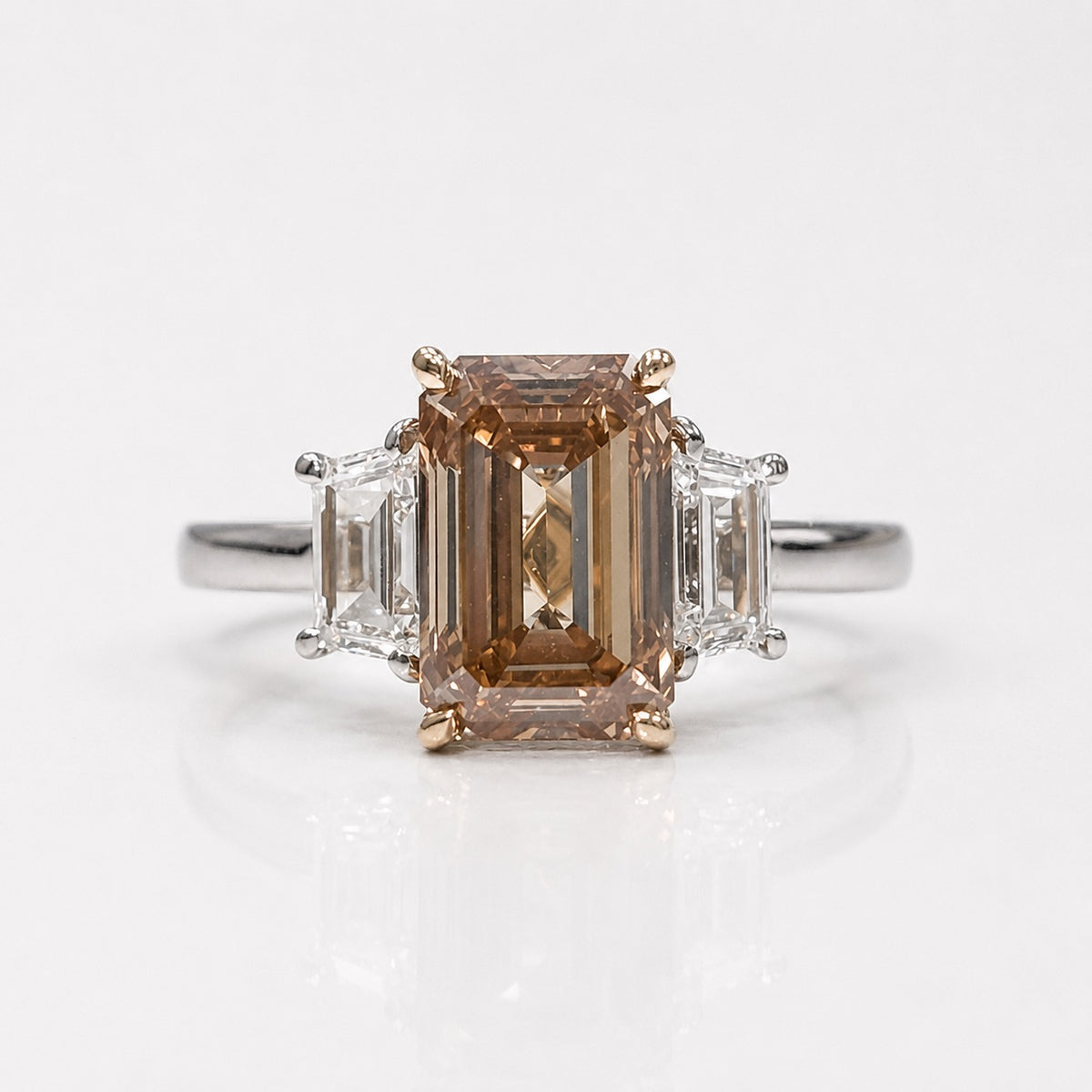 3ct fancy brown-orange emerald cut diamond three stone engagement ring with trapezoid sides | Rare Colors by Namdar, NYC
