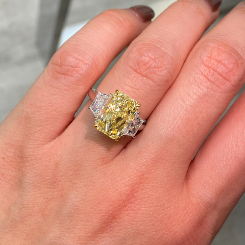 GIA certified fancy yellow elongated radiant diamond engagement ring with a striking center with a VVS2 clarity.