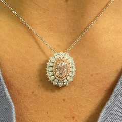 Fancy natural light pink elongated cushion cut set in white diamond white gold ring.