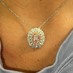 Fancy natural light pink elongated cushion cut set in white diamond white gold ring.