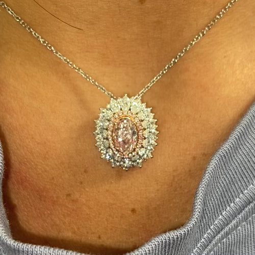 Fancy natural light pink elongated cushion cut set in white diamond white gold ring.