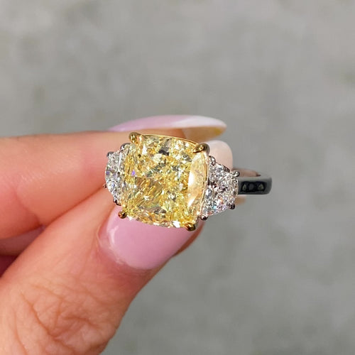 Video of 7 carat yellow diamond ring with two white diamonds 