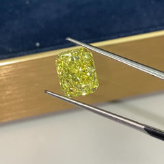 Unique GIA certified fancy vivid yellow elongated radiant cut diamond with flawless clarity.