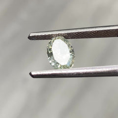 Video of Oval-shaped green diamond on a light gray background