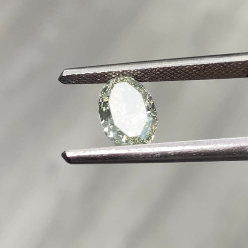 Video of Oval-shaped green diamond on a light gray background