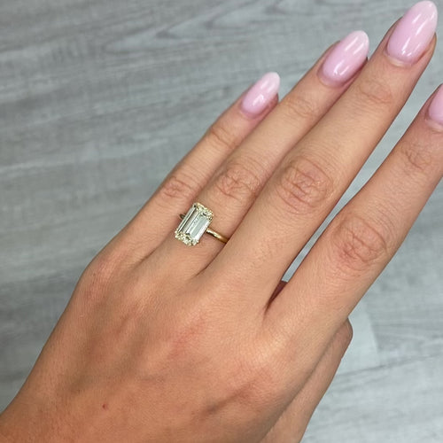 Unique elongated light yellow emerald cut diamond, GIA certified with excellent clarity.