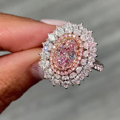 Fancy natural light pink elongated cushion cut set in white diamond white gold ring.