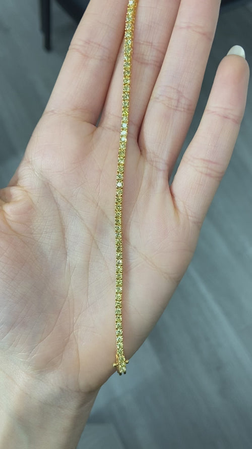 Fancy round shaped intense yellow diamond tennis bracelet, GIA certified with VS clarity.