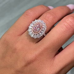 Fancy natural light pink elongated cushion cut set in white diamond white gold ring.