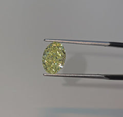 Fancy yellow oval cut diamond with excellent clarity and precision, GIA certified.