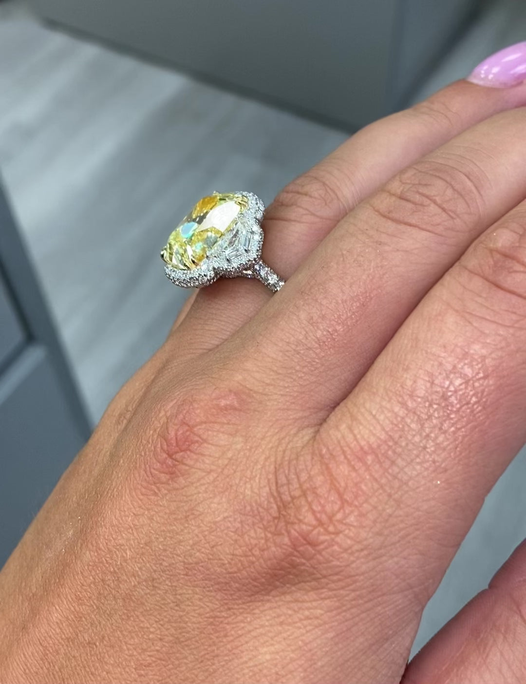 13.30 carat yellow diamond on the center with white surrounding diamonds
