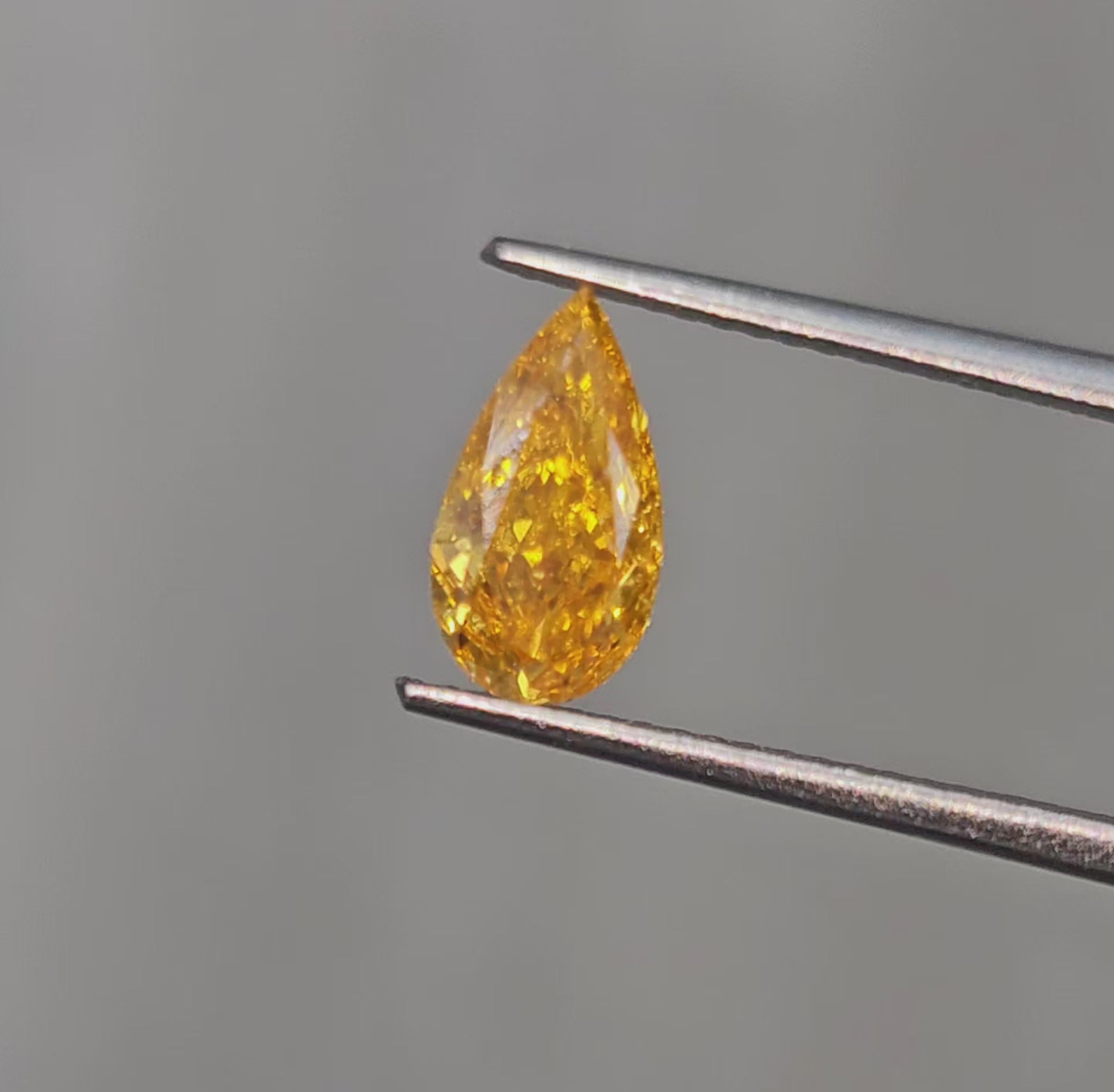 Unique Radiant Orange-Yellow Pear Shaped Diamond.