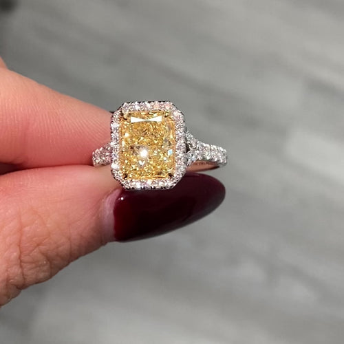 Old money yellow diamond ring with White Halo diamonds with a VS2 clarity.