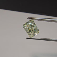 GIA certified Fancy Green-Yellow elongated radiant cut diamond with VVS2 clarity and vibrant color.