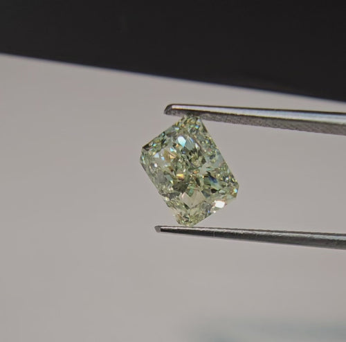GIA certified Fancy Green-Yellow elongated radiant cut diamond with VVS2 clarity and vibrant color.
