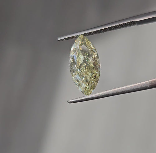 GIA certified Fancy Light Yellow elongated cushion cut diamond, VVS1 clarity and vivid color.