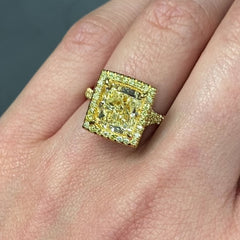 GIA certified light yellow elongated cushion cut halo diamond engagement ring with canary yellow, SI1 clarity.