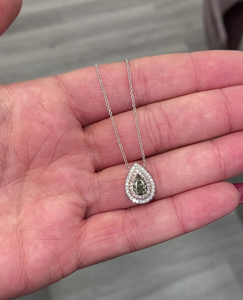 Unique green chameleon pear-shaped diamond pendant with double halo and VS1 clarity center diamond.