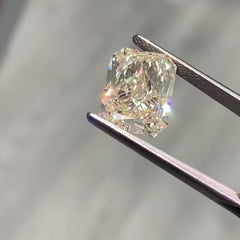 Unique light yellow elongated radiant cut diamond with VS2 clarity and warm, vibrant hue.