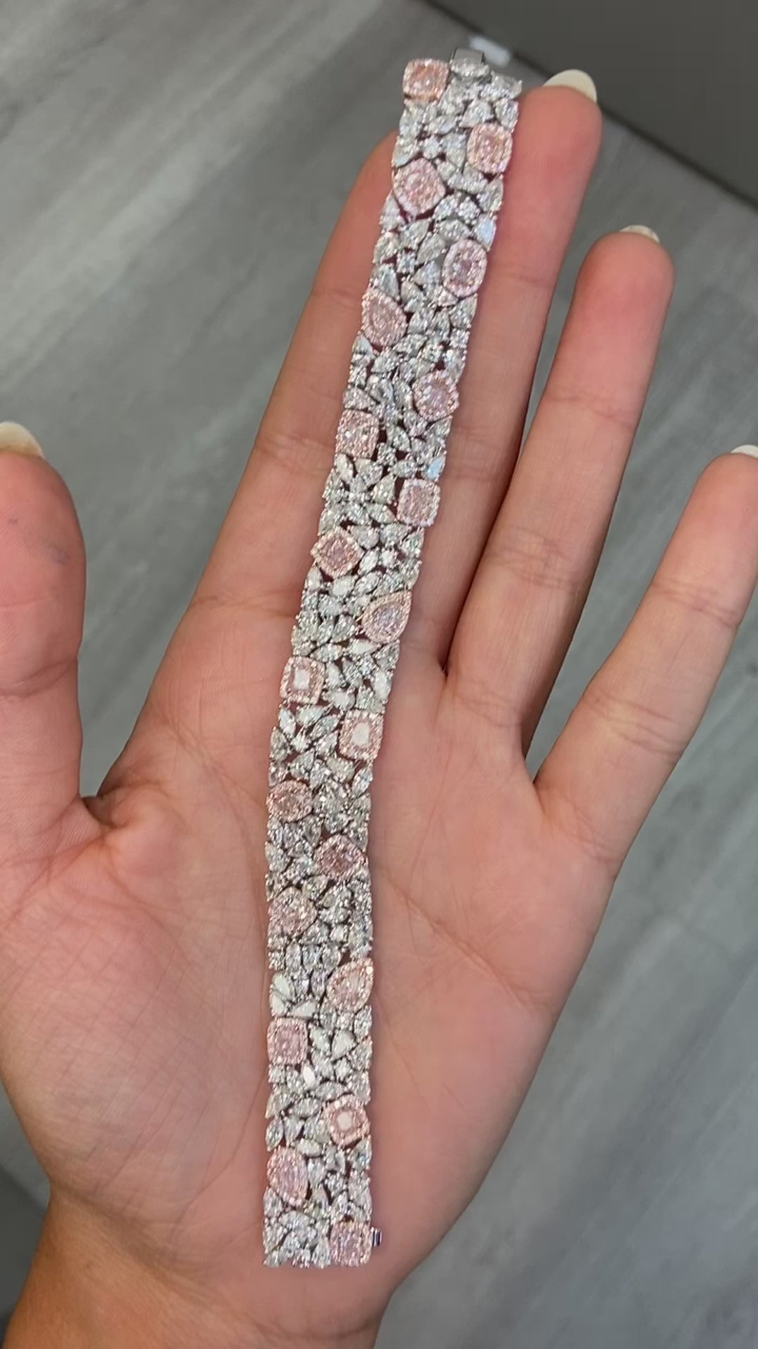 GIA certified light pink cushion and pear shape diamonds with white diamond bracelet.