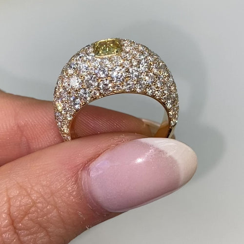 Elongated yellow diamond surrounded by white diamonds ring