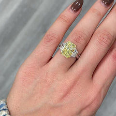 GIA certified fancy yellow elongated radiant diamond engagement ring with a striking center with a VVS2 clarity.