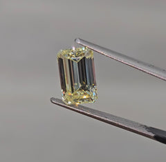 Unique elongated light yellow emerald cut diamond, GIA certified with excellent clarity.