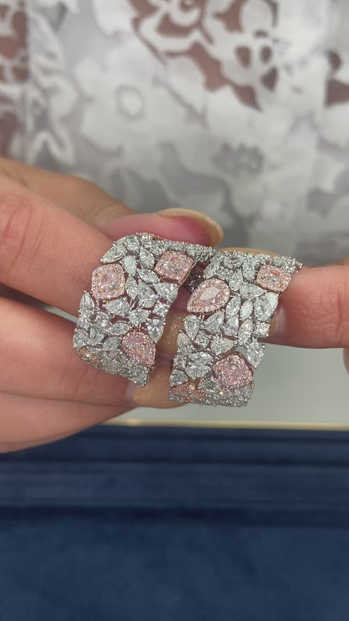 GIA certified light pink cushion and pear shape diamonds with white diamond bracelet.