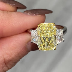 GIA certified fancy yellow elongated radiant diamond engagement ring with a striking center with a VVS2 clarity.