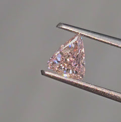 GIA certified Fancy Orangy Pink trillion diamond with SI1 clarity and vibrant hue. 