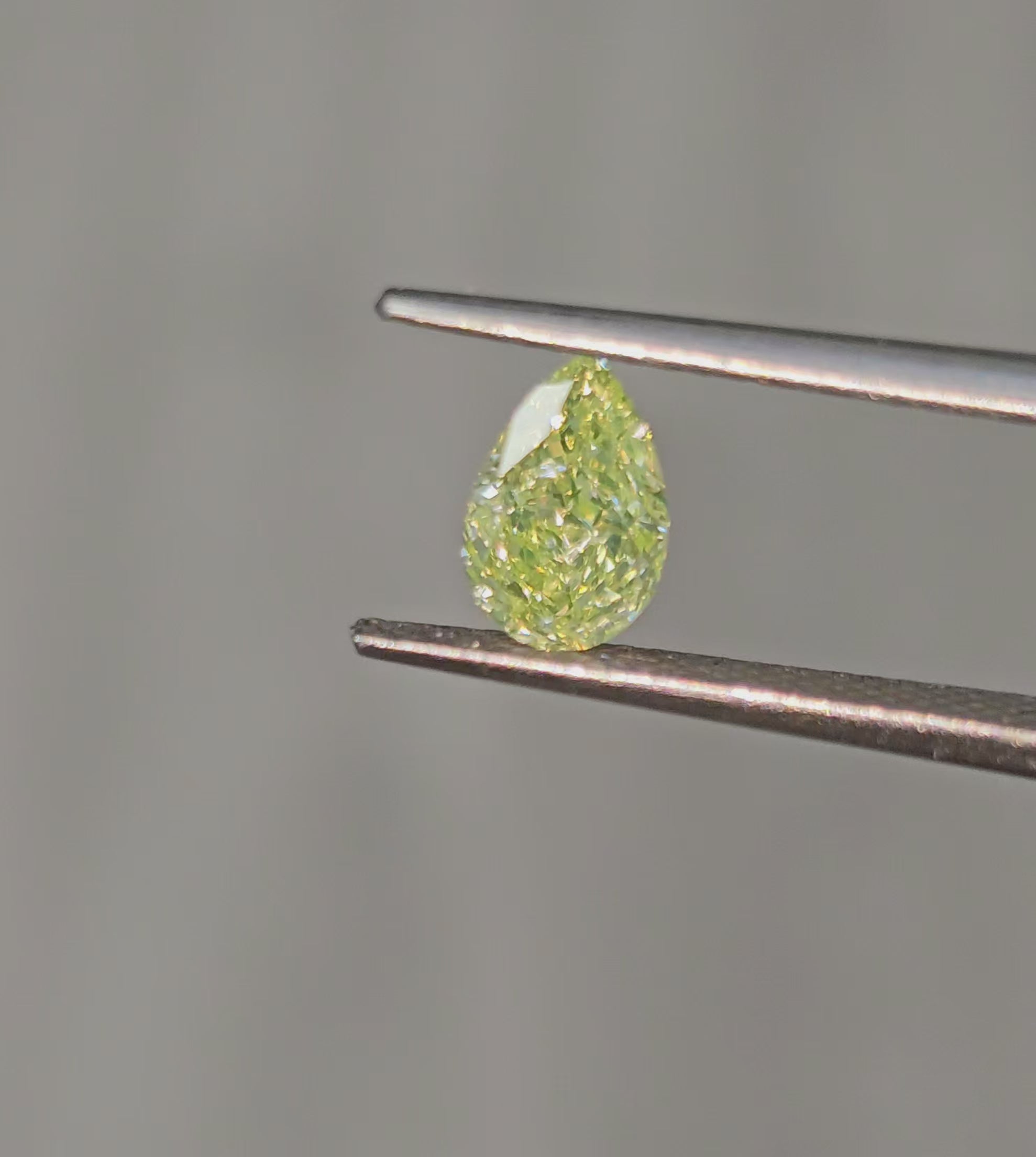 Fancy Light Green-Yellow pear-shaped diamond with VS2 clarity and a stunning hue.